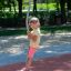 Child playing on Spinner I playground equipment in park
