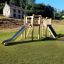 Alstad Eco wooden playground climbing frame with slide on grassy field