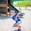 Child playing on Spinner II playground equipment.