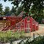 Red Barn playground climbing structure with slide in outdoor play area