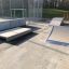 Portable skate ramps, including a flat ramp and a curved Jump-Ramp, on a concrete surface in a skate