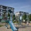 Young explorer with a climbing wall playground equipment with slide and rope bridge