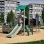 Fortress with a slide playground equipment with children playing outdoors