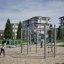 Chimpanzee metal playset with climbing frame and horizontal bars on outdoor playground