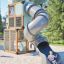 Box "Breeze" with a slide playground equipment with a child sliding down outdoors