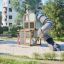 Box "Breeze" with a slide playground equipment in a park setting