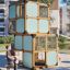 Box "Breeze" with a slide playground equipment made of wooden frames and blue panels with children p
