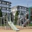 Alpha Centauri playground climbing frame with slide and tube tunnel in urban park setting
