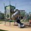 Alpha Centauri playground equipment with spiral slide and climbing nets in outdoor park