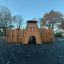 Wooden playground structure Scandinavian stronghold with slide and climbing walls in autumn park set