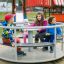 Children playing on Merry-Go-Round in a playground.