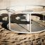 Playground Merry-Go-Round with metal structure on sandy ground.