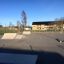 Curb Sloping - height: 15-25cm in a skate park with other ramps and buildings in the background