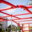 Cross Climber steel structure in playground with red bars