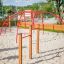 Red Cross Climber steel structure on a playground with sand.
