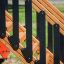 Wooden stairs of Logo Tower Nature single slide with black handrails in playground setting