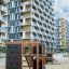 Climbing Kiosk Nature wooden climbing frame with black panels in urban playground.