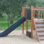 Romping Center Nature playground slide and stairs in a park setting.