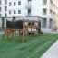 Romping Center Nature playground set in a residential area with artificial grass.