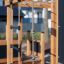 Wooden play structure with ropes and ladders from Romping Center Nature.