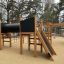 Wooden playhouse with slides and climbing activities, Motor Function Center Nature.