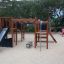 Playground equipment Challenger Nature with a slide and climbing structure on a sandy area.