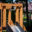 Challenger Nature wooden playground with slide in a backyard setting
