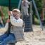 Silver Cableway playground zip line with child riding on sandy surface