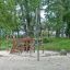 net climbing frame on the playground nearby the forest