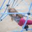 a girl playing on the net climbing frame