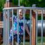 Square Play Nature playground equipment with a toddler enjoying the play area.