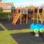 Wooden playground equipment Square Play Nature with slides, ladders, and spring toys in a park.