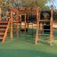 Outdoor playground equipment Square Play Nature with wooden structures and climbing elements.