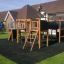 Playground equipment 'Square Play Nature' in a grassy backyard setting.