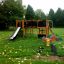 Playground structure Square Play Nature with slide and climbing elements in a park