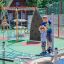 Children playing on Balances playground equipment by Lars Laj, featuring colorful climbing and balan