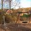 Balance equipment and round swing in a children's playground.