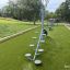 Outdoor children's balance equipment 'Balances' on a grassy playground.