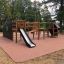 Wooden King-Kong Nature II castle with a slide on a playground.