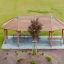 Long Firehouse wooden playground shelter with benches and roof viewed from above.