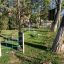 Steel playground equipment among trees in a park