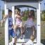 Children playing in the Sand Pavilion Nature single playhouse.