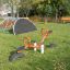 Mini Climber steel structure in a playground, including climbing net and red seesaw.