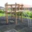 Sherwood wooden playhouse with climbing structures in a backyard playground.