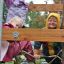 Children playing on Sherwood wooden playhouse on a rainy day.