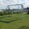 Silver Double Swing set on a grassy area near a marina
