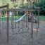Yellowstone wooden climbing frame with rope net and slide on playground.