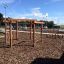 Wooden playhouse structure with climbing nets at a playground – Yellowstone wooden playhouse