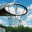 Outdoor metal basketball hoop against a blue sky.