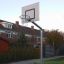 Outdoor basketball hoop on a metal pole in a residential area